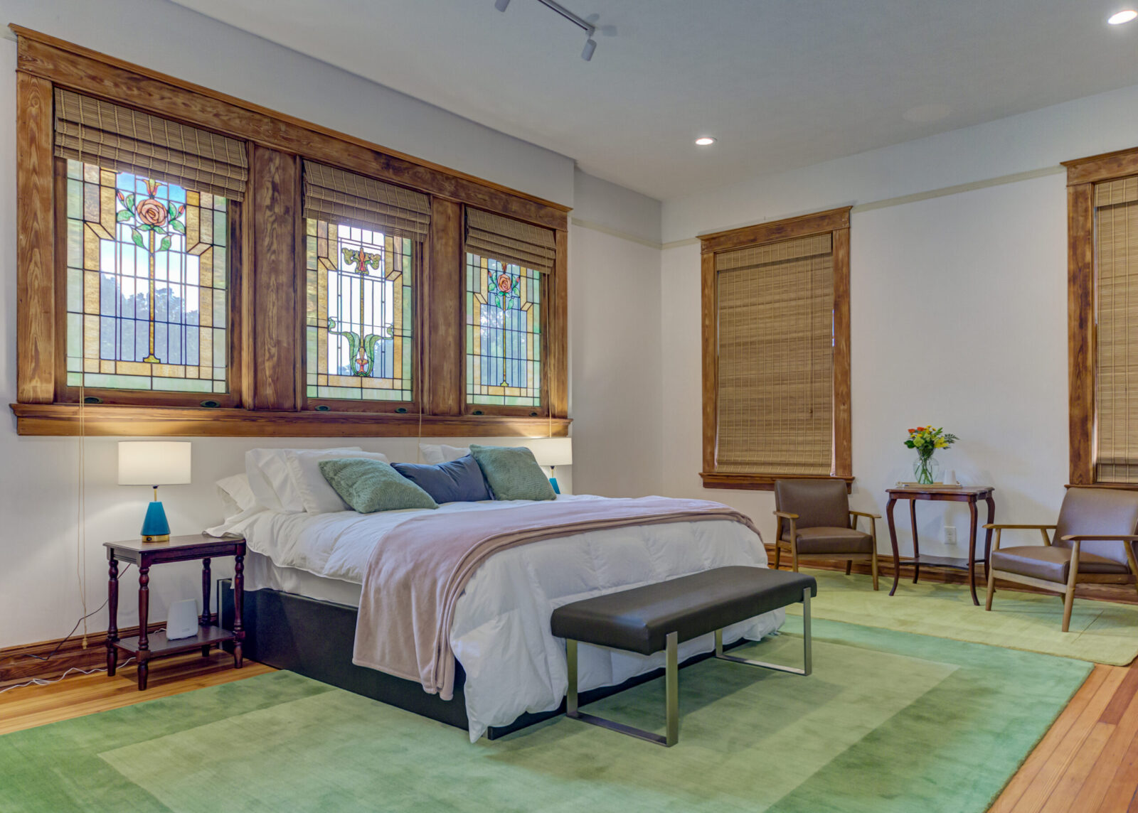 The Louis Suite features a king bed and original stained glass windows