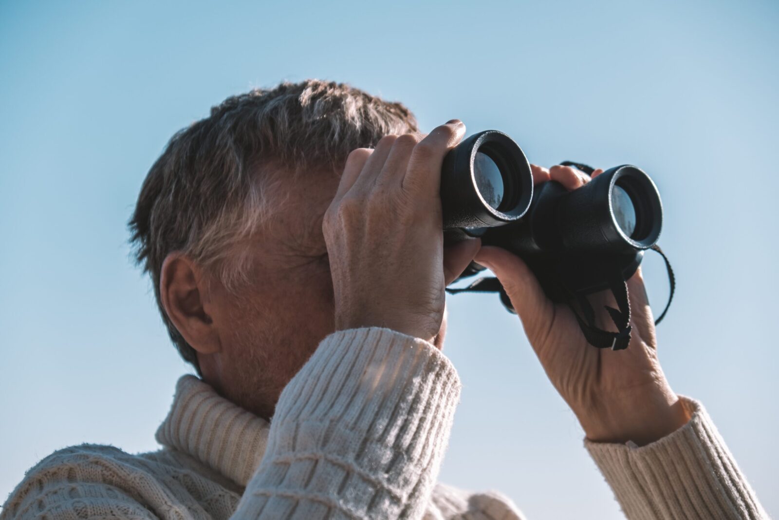 Gentleman with binoculars watching raptor migration at Hawk Mountain Sanctuary