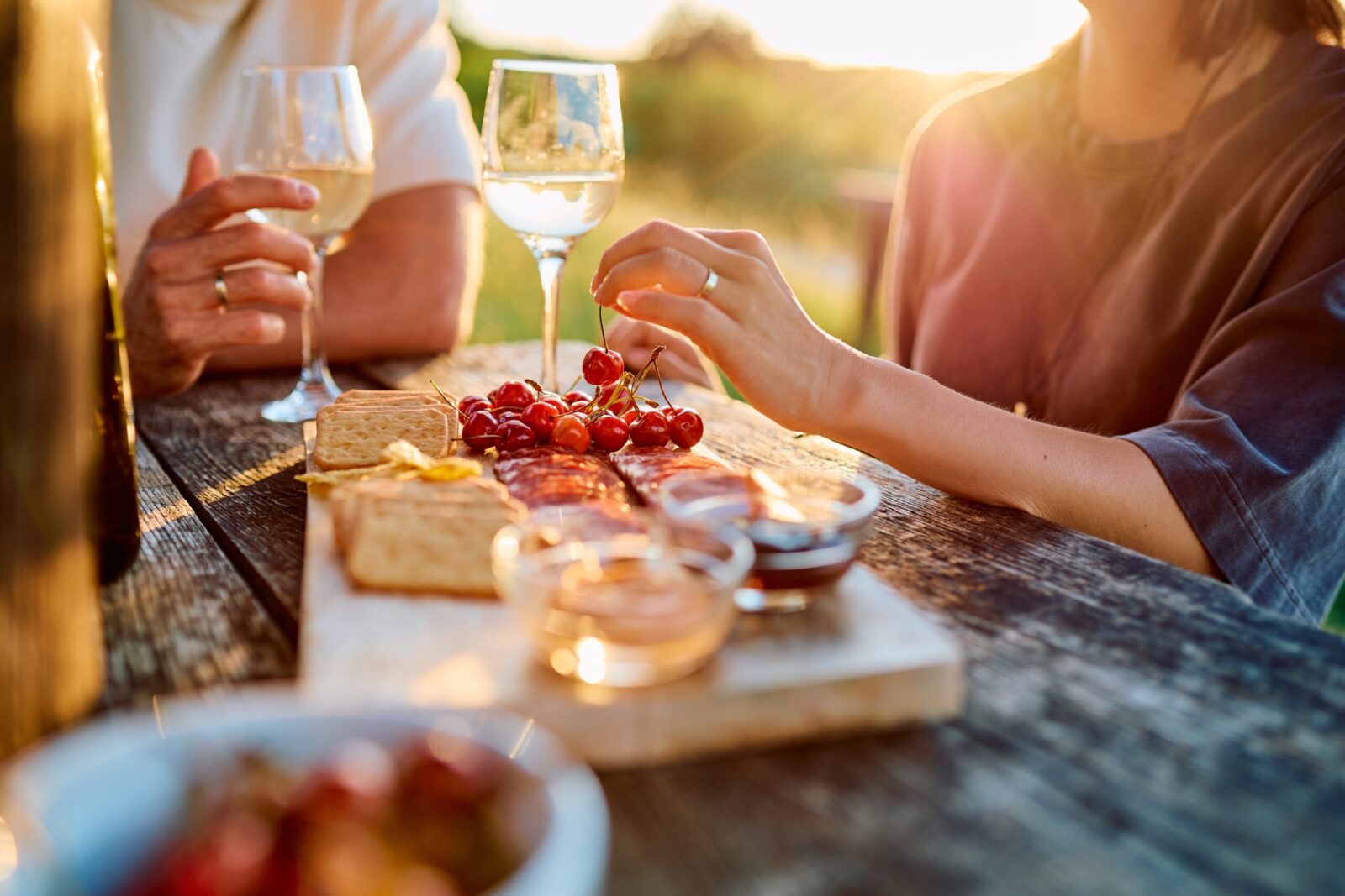 Couple sharing wine over a charcuterie board at Balanced Rock Winery in Baraboo