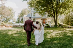 Couple walking back toward Inn after ceremony at our wedding venue in PA