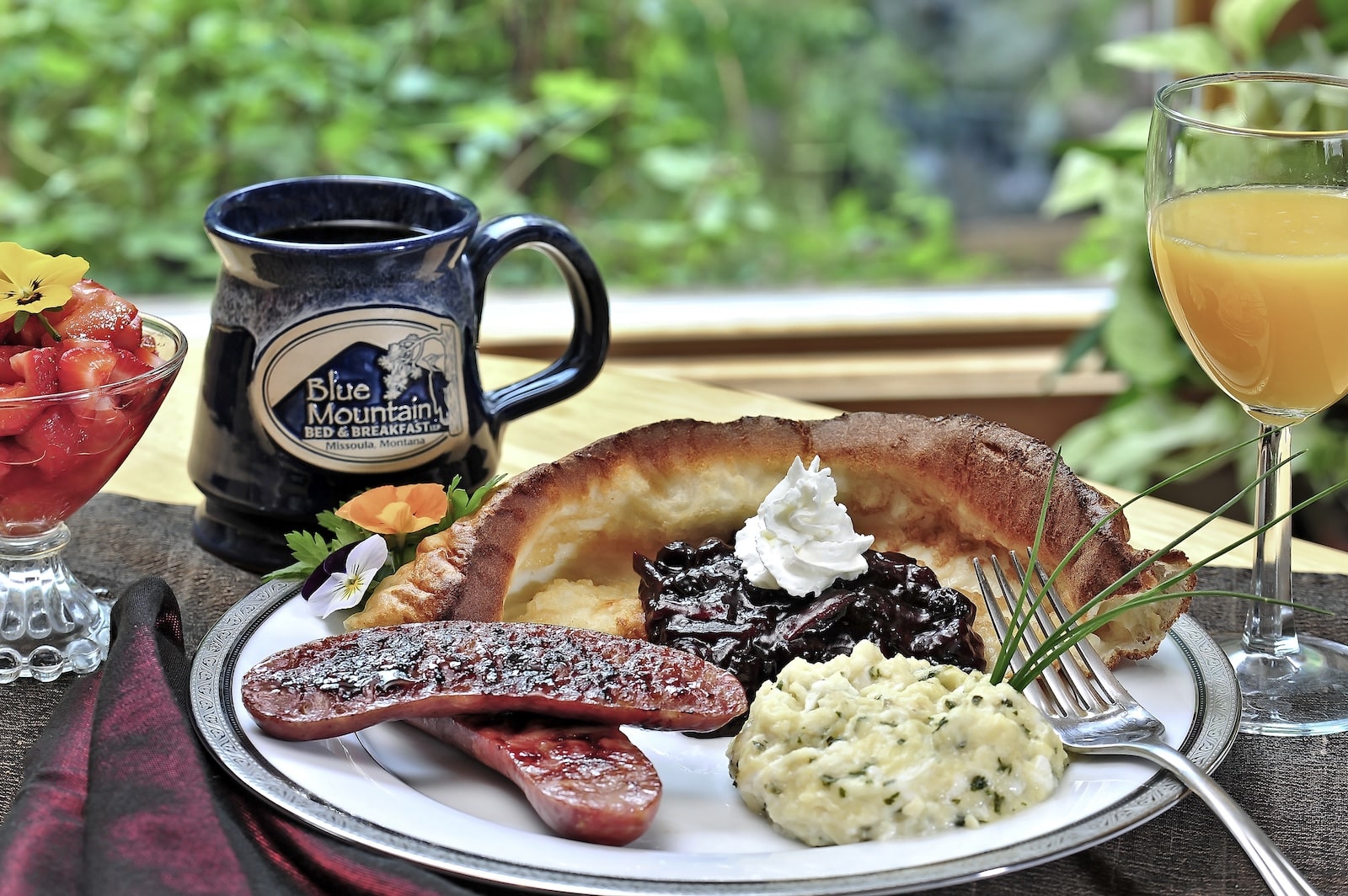 Breakfast of a Dutch pancake, sausage, and grits at a Bed and Breakfast Montana.