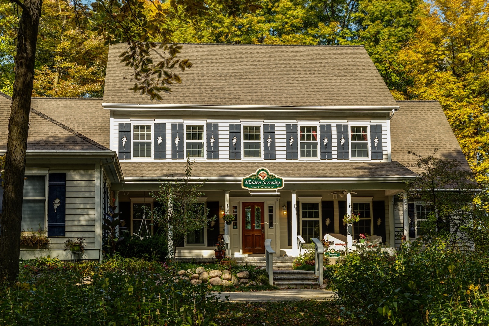 The exterior of a Bed and Breakfast in Wisconsin surrounded by Wisconsin fall colors.