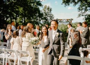Couple after their wedding ceremony walks back down the aisle past guests on the lawn at our wedding venue in PA