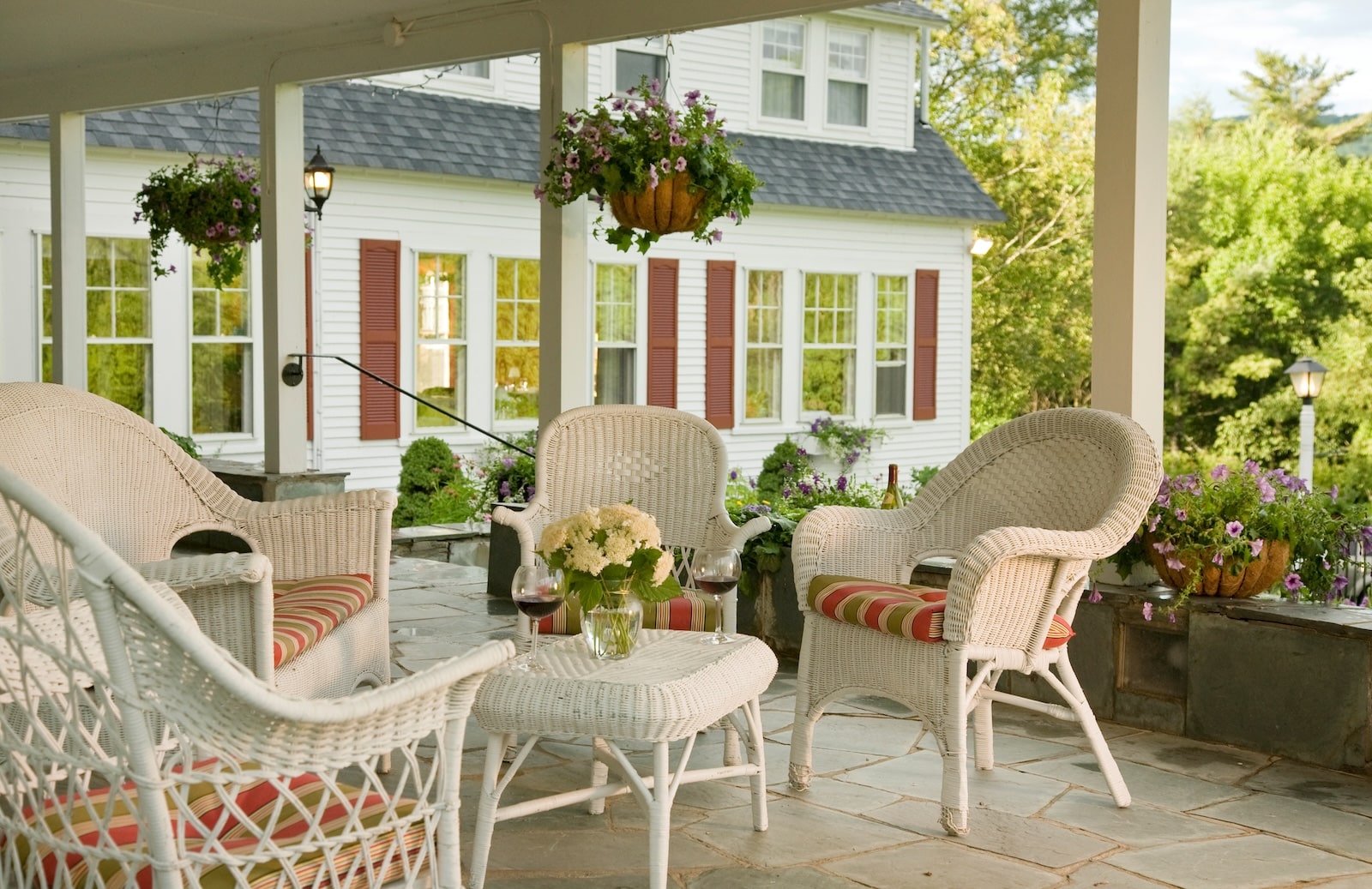 White wicker porch seating at a bed and breakfast in New Hampshire.