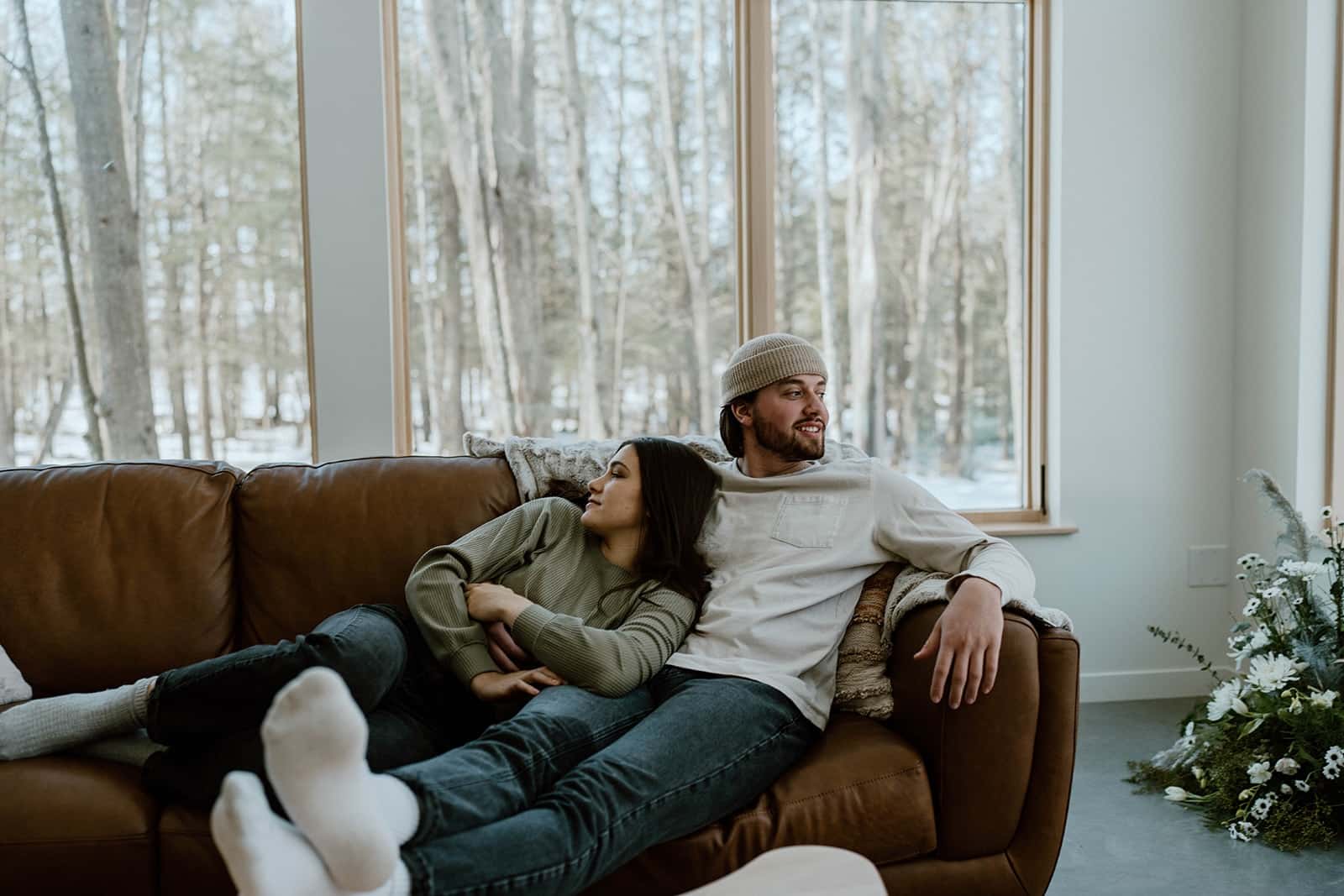 A couple lounging on a couch at one of the most romantic cabin getaways in Wisconsin.