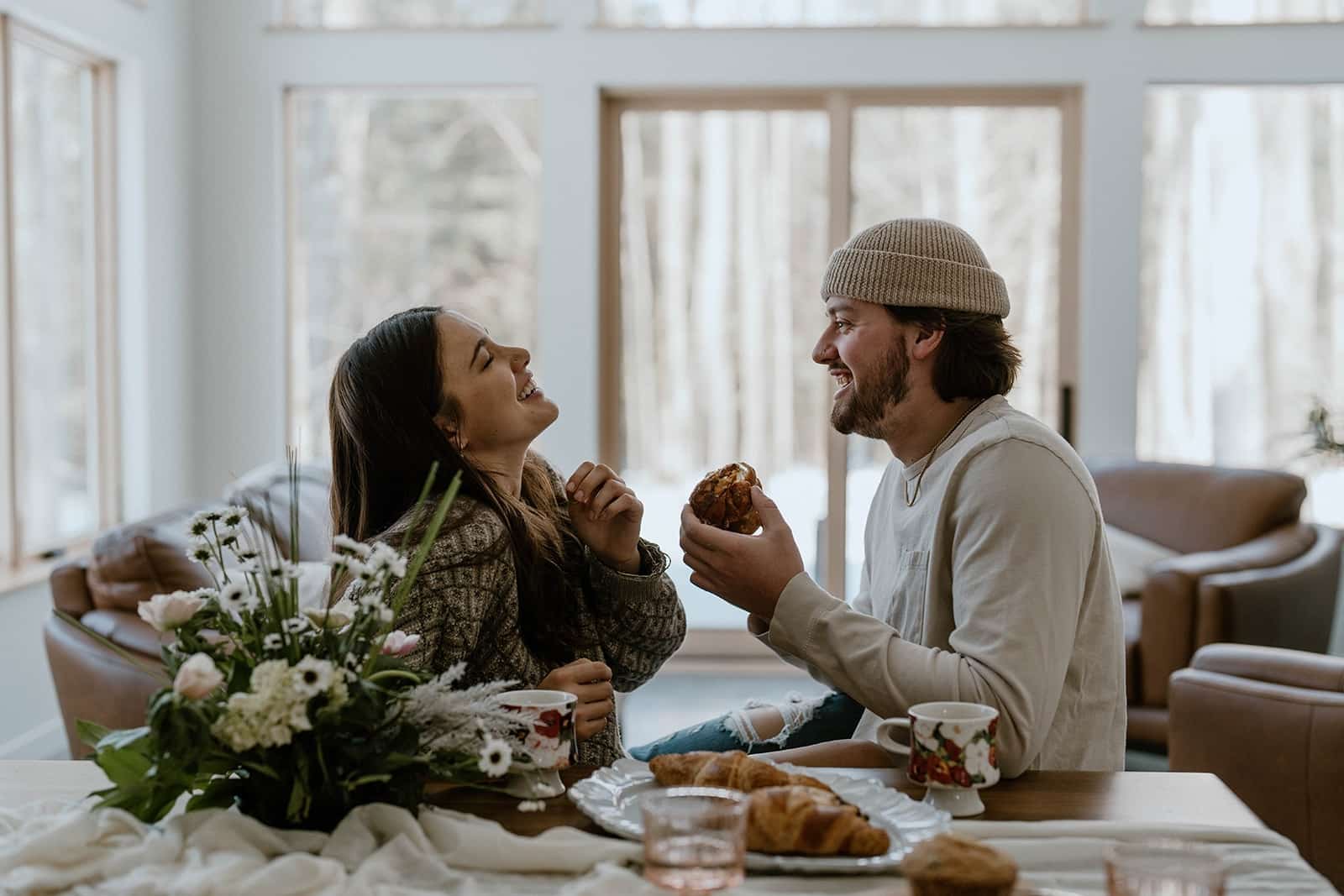 A couple engjoying coffee and croissants at one of the most romantic cabin getaways in Wisconsin.