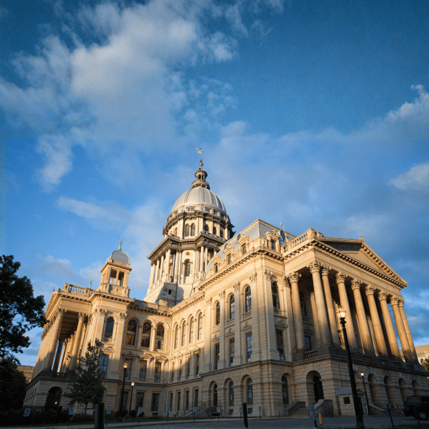Historic Illinois State Capitol building under blue skies at sunset in downtown Springfield, Illinois, ideal for couples exploring cultural Midwest weekend trips.