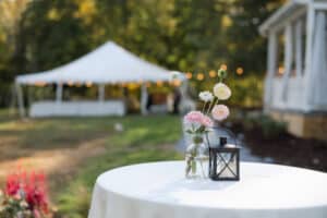 Table set with flowers and tent in the background at our wedding venue in PA