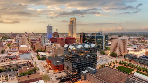 Downtown Omaha, Nebraska skyline showing modern buildings and historic architecture under a evening sky