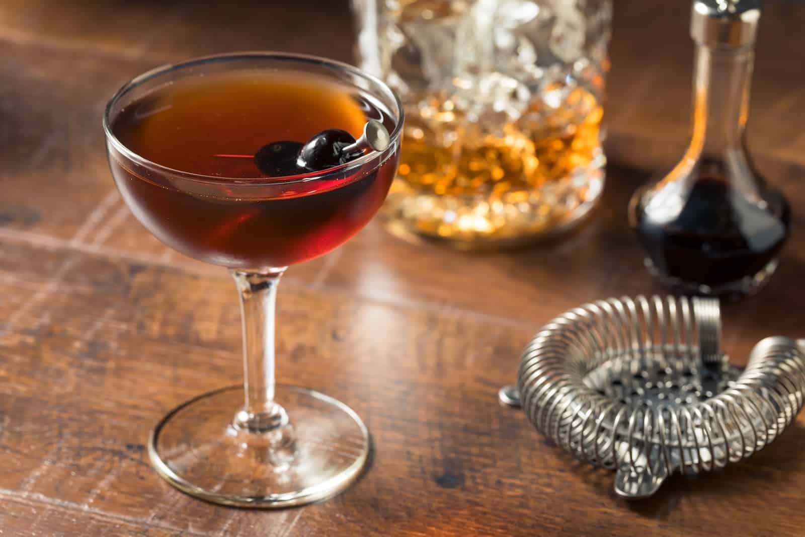 Refreshing Boozy Manhattan Cocktail with Vermouth and cherry garnish, what you'll find at a Wisconsin supper club.