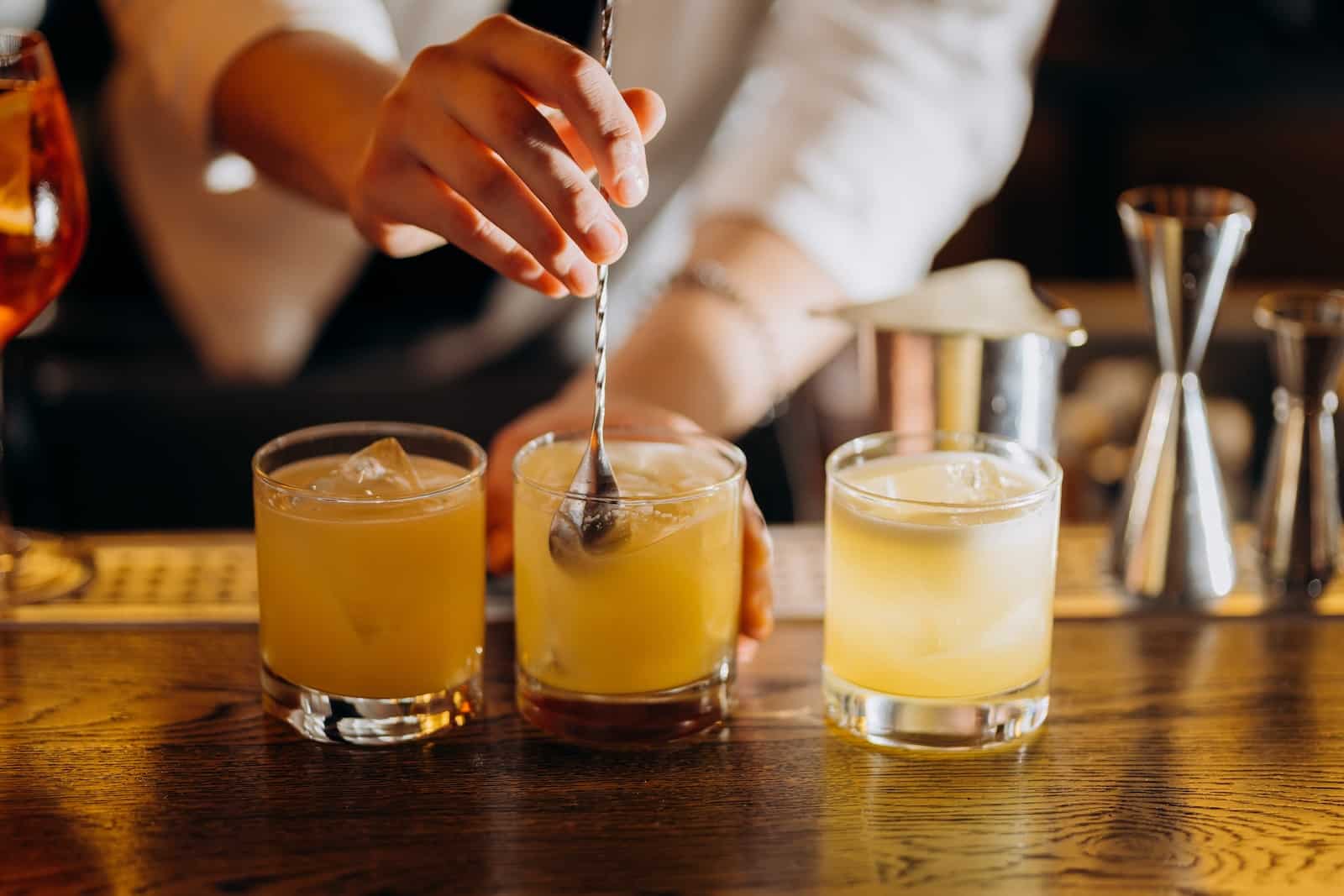 Bartender stirring craft cocktails at Timekeeper Distillery in Wausau WI.