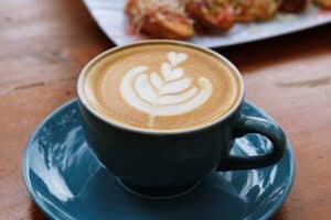 Hot Latte in blue cup in cozy cafe in Old Town Eureka