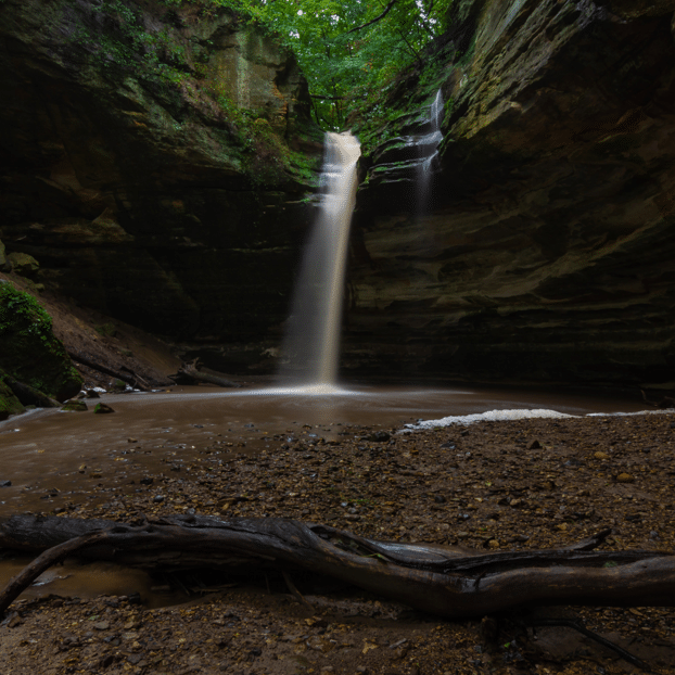 Scenic canyon waterfall flowing into a pool at Starved Rock State Park near Oglesby, Illinois, a secluded nature escape for couples staying at nearby Midwest inns.