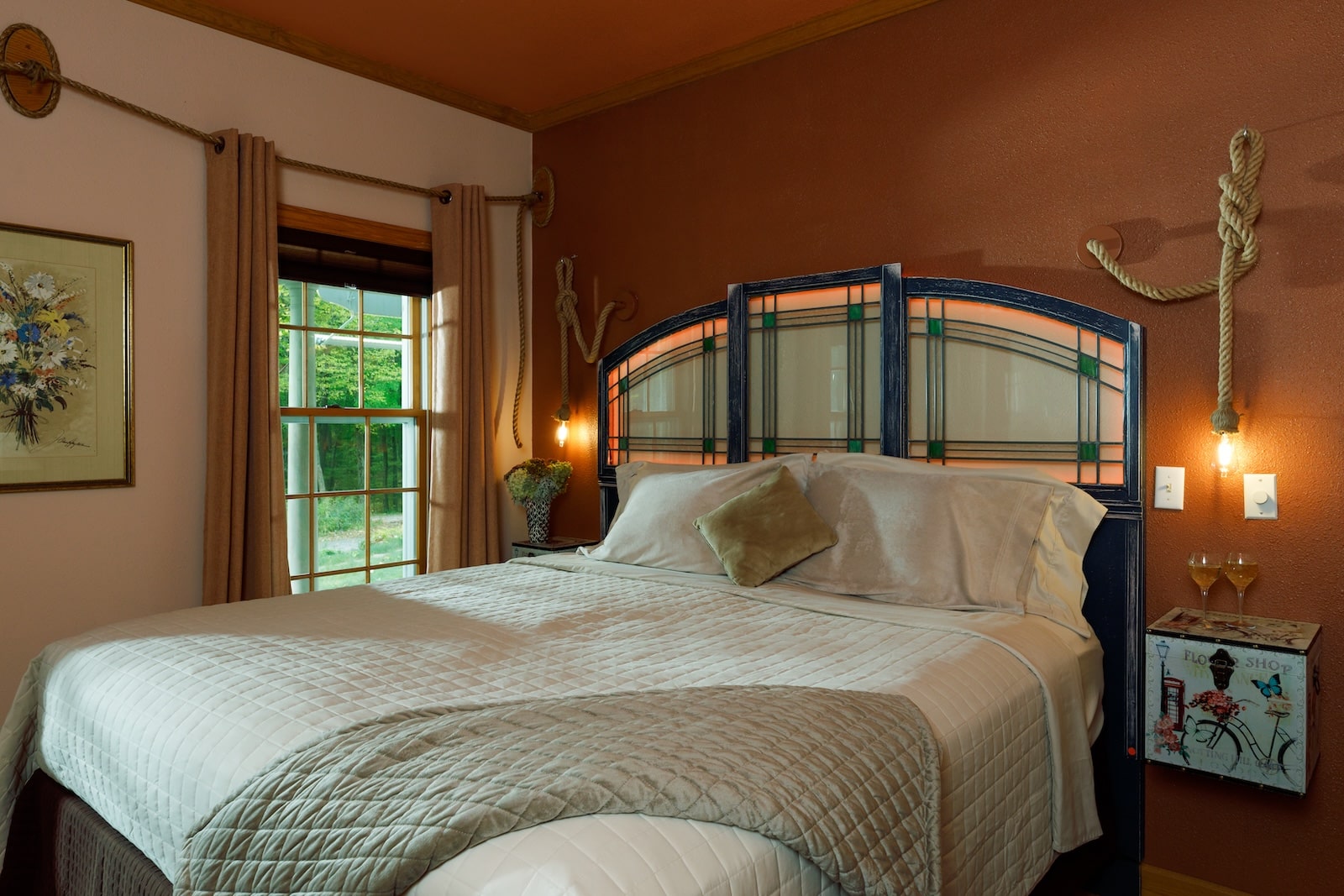 A guest room at a Bed and Breakfast in Wisconsin with a cozy bed and lamps by a window.