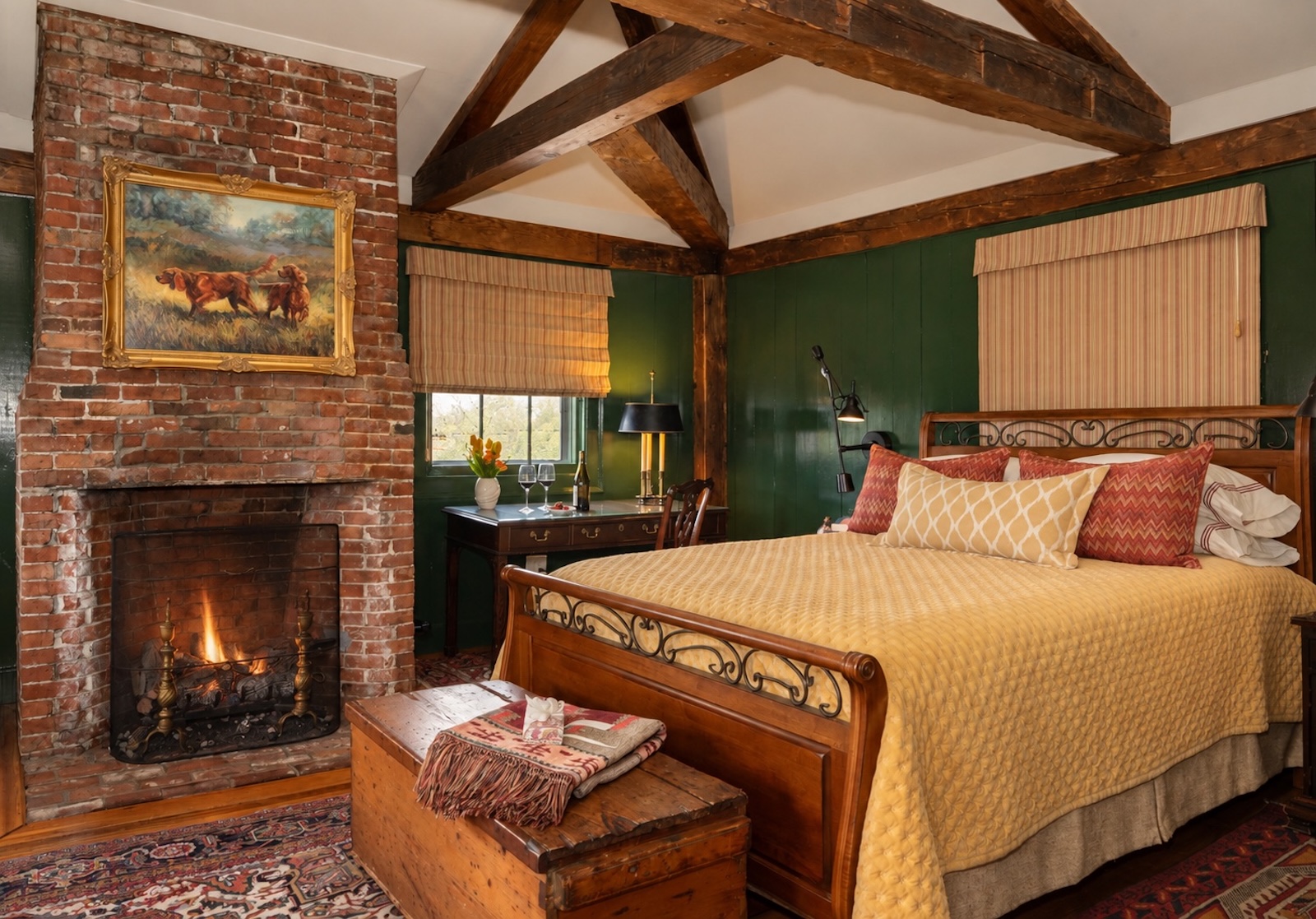 One of the best historic hotels in New Hampshire, featuring a guest room with a bed by a fireplace.