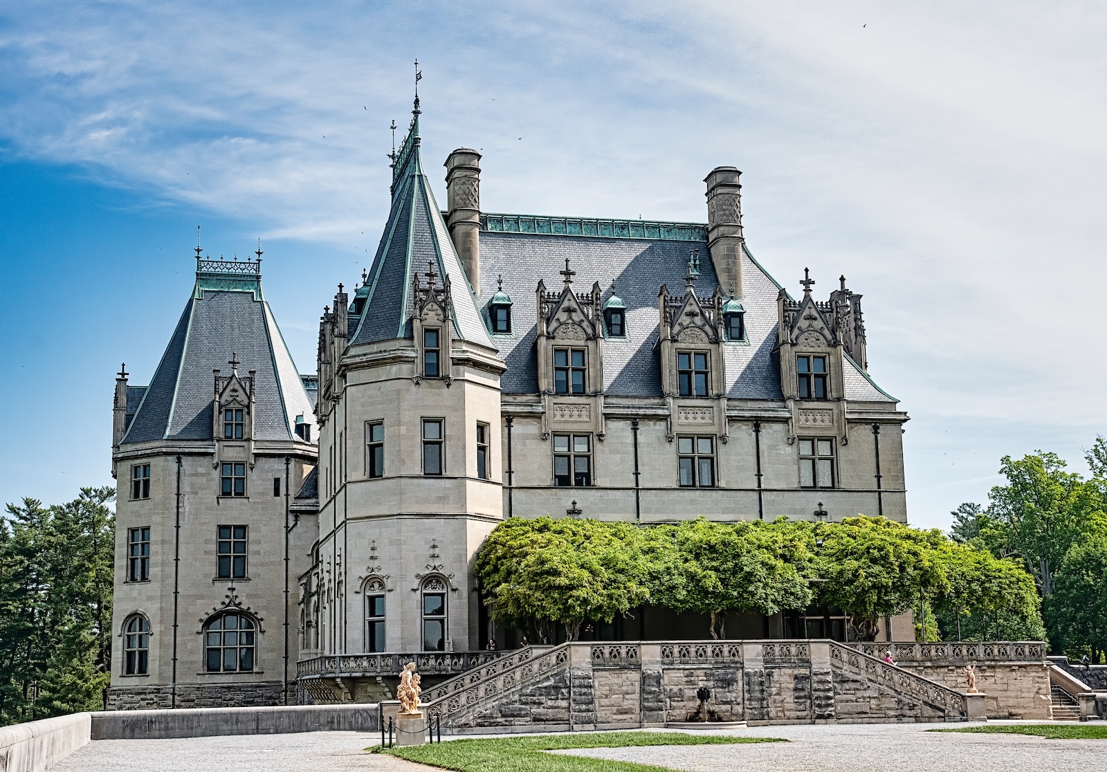 When you buy Biltmore Estate tickets, you'll get access to the grounds and house that looks like a castle, surrounded by greenery and statues.